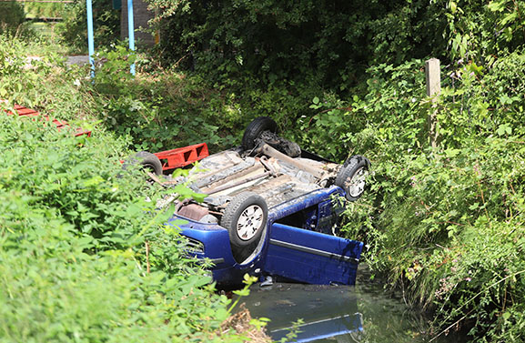 Auto op zijn kop in de sloot in Ophemert